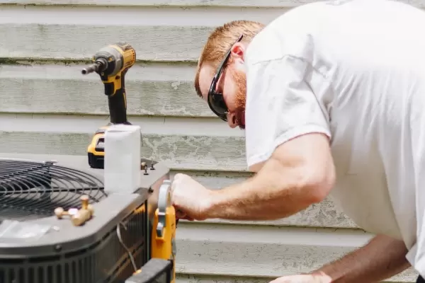 Hvac Technician Performing Maintenance On Condensor 2