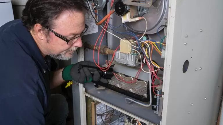 Hvac Technician Repairing Furnace