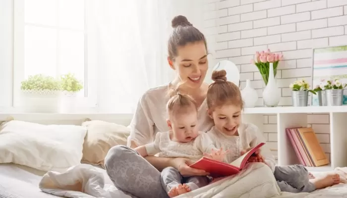 mom reading in bed with kids